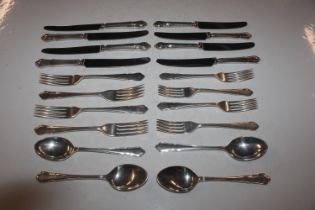 A suite of silver cutlery comprising of four dinne