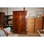 A Victorian mahogany wardrobe fitted sliding trays, drawers and hanging compartments enclosed by