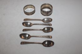 Five silver coffee spoons and two silver napkin ri