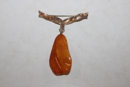 A 9ct gold bow brooch hung with amber drop
