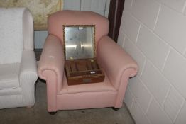 A pink upholstered armchair