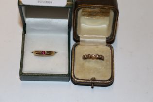 A yellow metal ring marked 585 set with coloured s