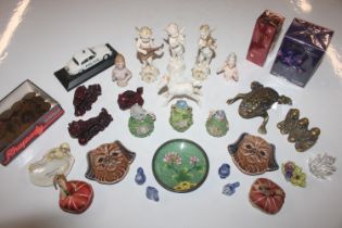 A box of various ornaments to include cherub ornam