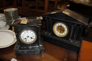 A Victorian black marble mantel clock with eight d