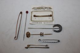 A yellow metal knot stick pin, other stick pins an