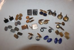 A bag of various cuff-links