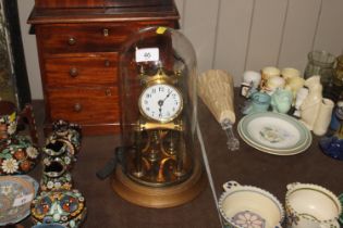 An anniversary clock contained in glass dome