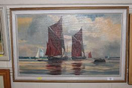 An oil on board depicting sailing barges, signed t