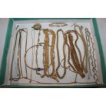 A box of gold tone jewellery, mainly necklaces