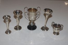 Three silver spill vases and two trophy cups, both