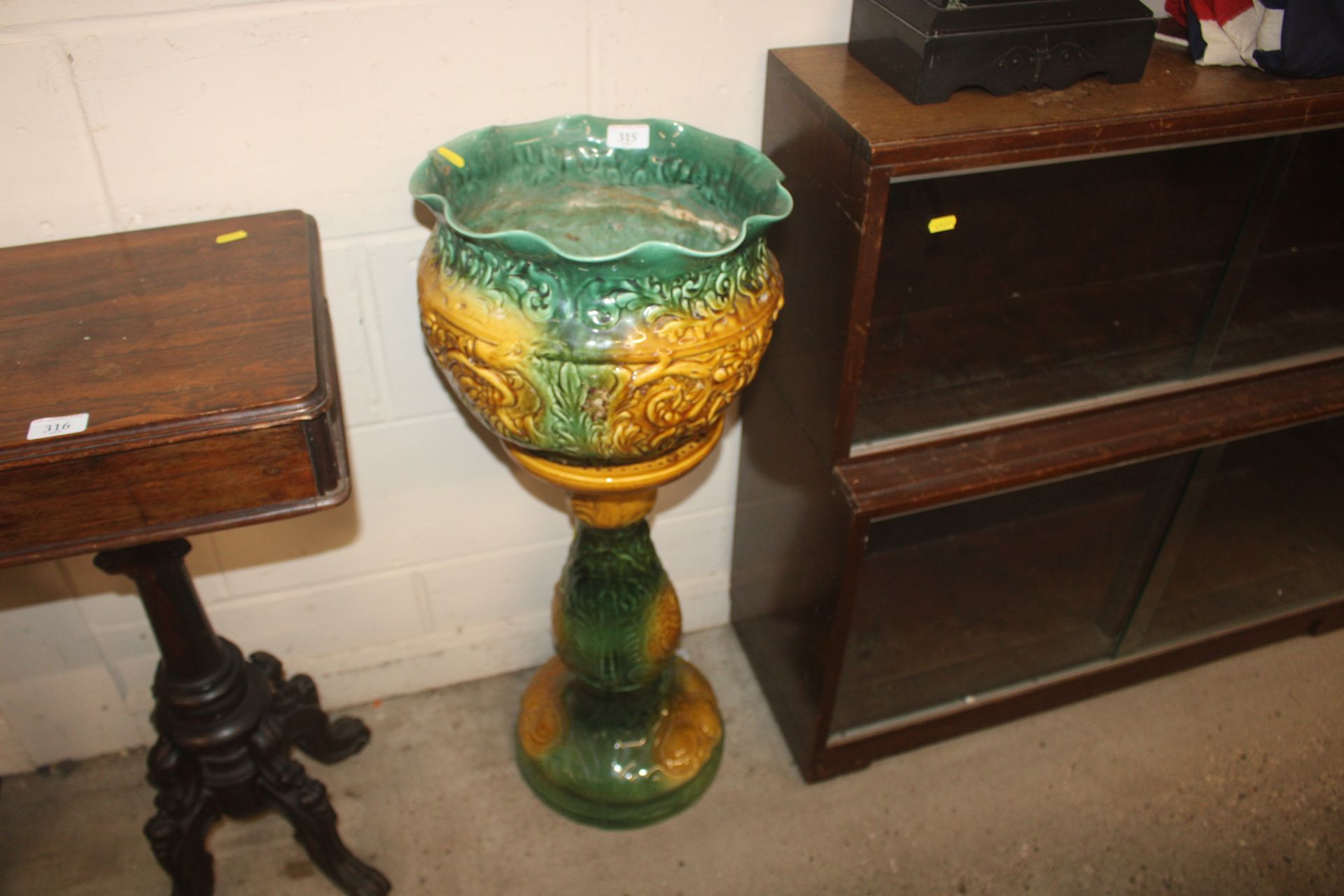 A Majolica style jardinière on stand