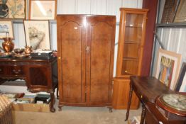 A walnut veneered wardrobe with fitted interior, r