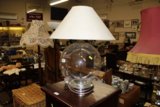 A glass table lamp and shade