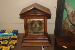 An oak cased German mantel clock with eight day movement