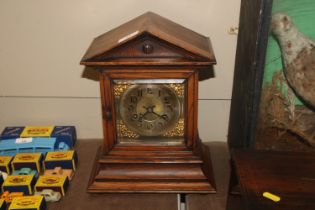 An oak cased German mantel clock with eight day movement