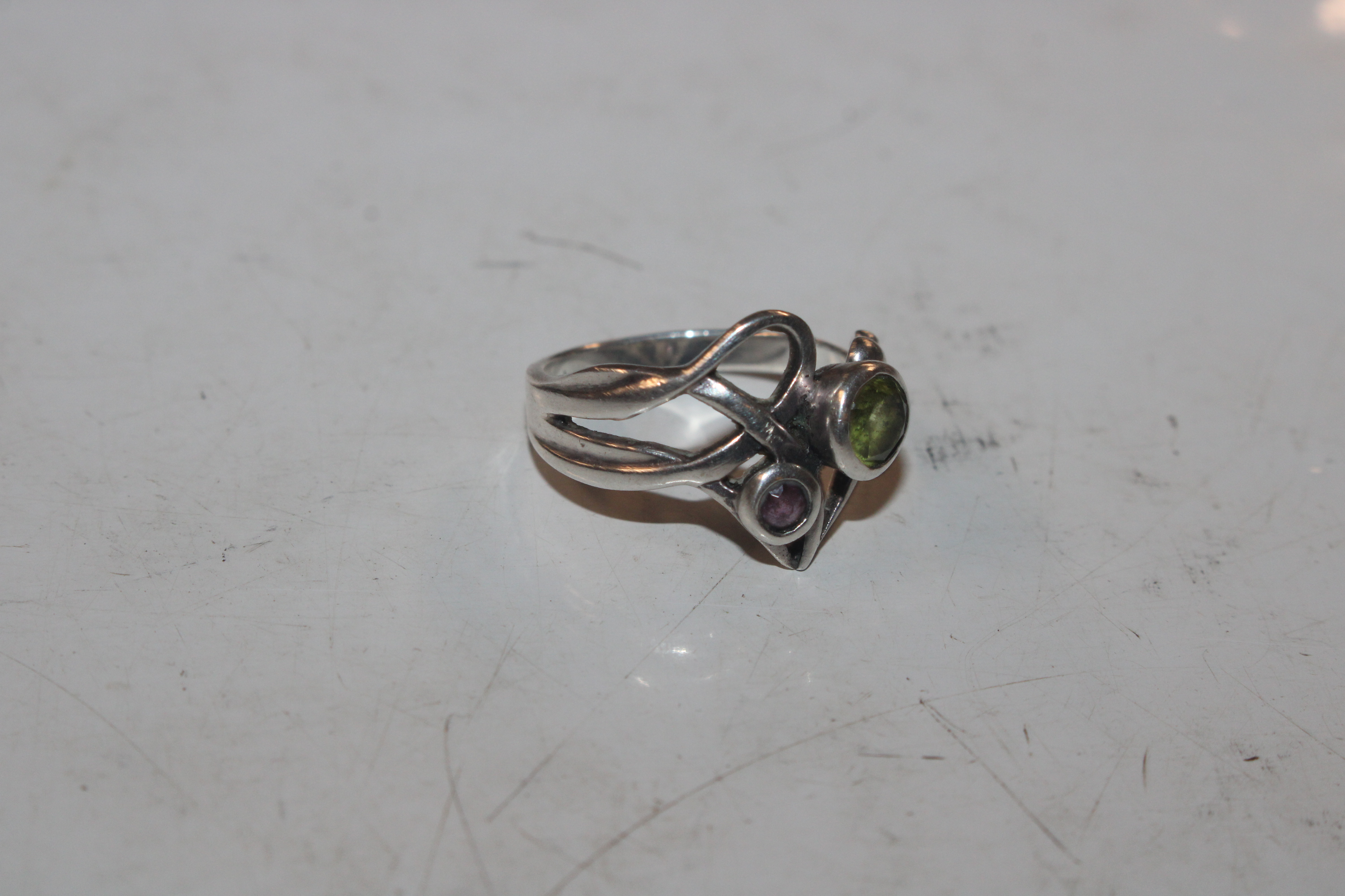 A 925 marked silver ring set with green and purple