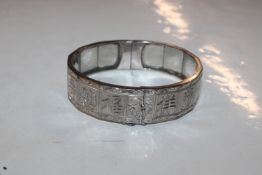 A white metal snap bangle (tested) containing silv