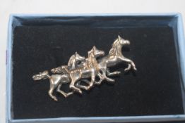 A vintage Sterling silver brooch in the form of ho