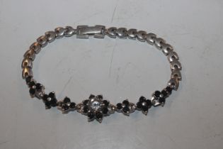 A silver bracelet of floral design set with large