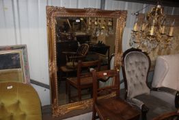 A large gilt framed bevel edge oblong wall mirror