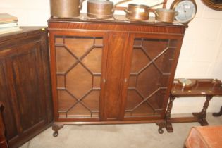 A mahogany astragal glazed bookcase, raised on squ