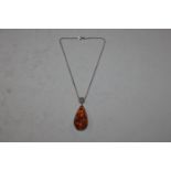A large Sterling silver and amber set pendant neck