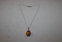 A large Sterling silver mounted amber pendant and