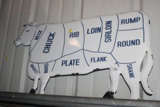 An enamel cow sign