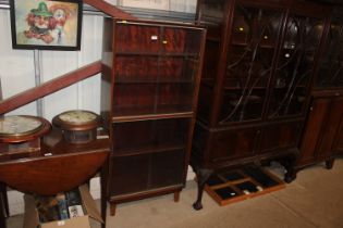 A Minty bookcase enclosed by glass sliding doors