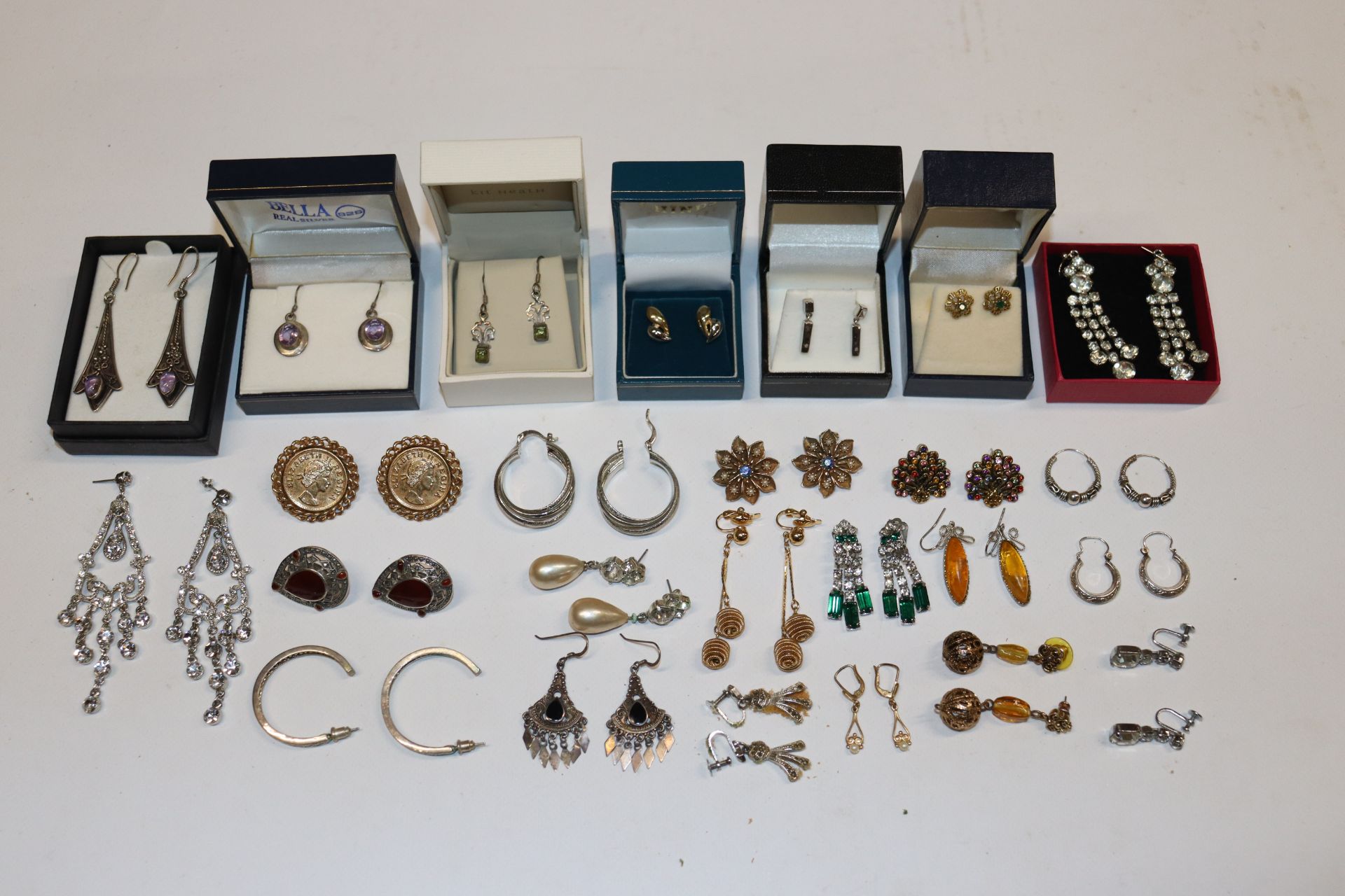 A box containing numerous pairs of decorative ear-r