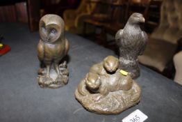 Three bronzed figures in the form of otters, owl an