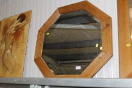 An octagonal pine framed bevel edged wall mirror