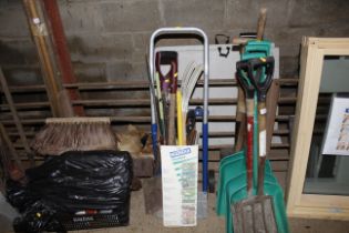 A bundle of gardening tools and a sack barrow