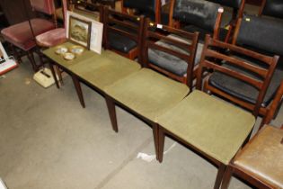 A set of four 1960s teak dining chairs
