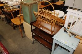 A mahogany three tier tea trolley, and a bamboo and wicker magazine rack