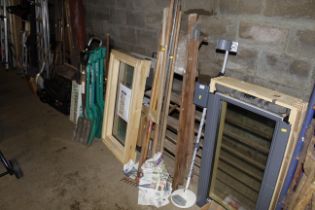 A bundle of long handled gardening tools and a woo