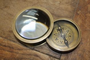 A brass cased navigating compass magnifier