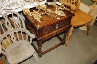 An Old Charm style carved oak bedside table fitted