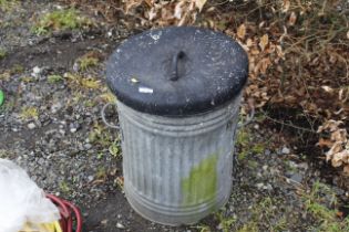 A galvanised dustbin and contents of various terra