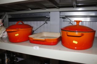 A Le Creuset baking dish and two similar style cas