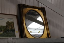 A small gilt framed wall mirror