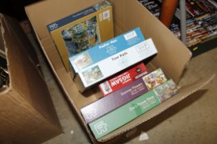 A box of various jigsaws