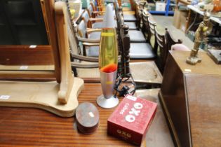 A lava lamp; a vintage Oxo tin and a vintage Macin