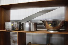 Various stainless steel saucepans and colanders