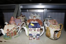 A collection of various novelty teapots