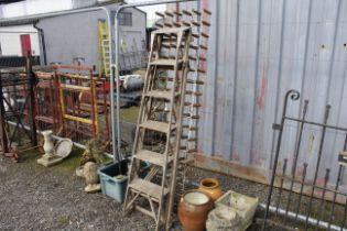 A wooden step ladder and a wooden and metal wine r