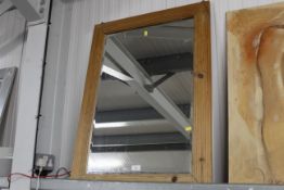 A pine framed bevel edged wall mirror