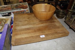 A large chopping board and a wooden bowl