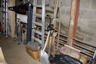 A bundle of long handled gardening tools