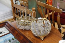 Two brass and glass pendent light fittings
